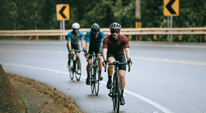 How should riders communicate with each other during group rides?